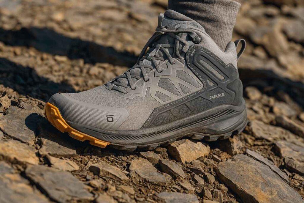 Oboz Katabatic Mid waterproof boot close-up on dry rocky ridge with shale — fast-and-light trail boot.