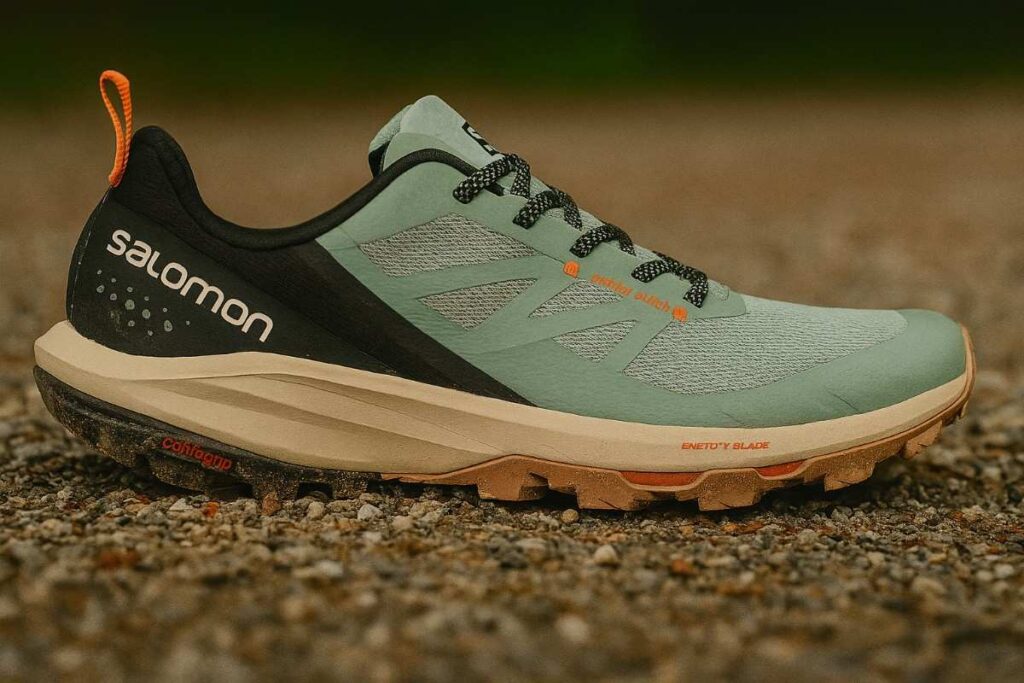 Salomon Outpulse hiking shoes on a gravel path, trail dust visible.