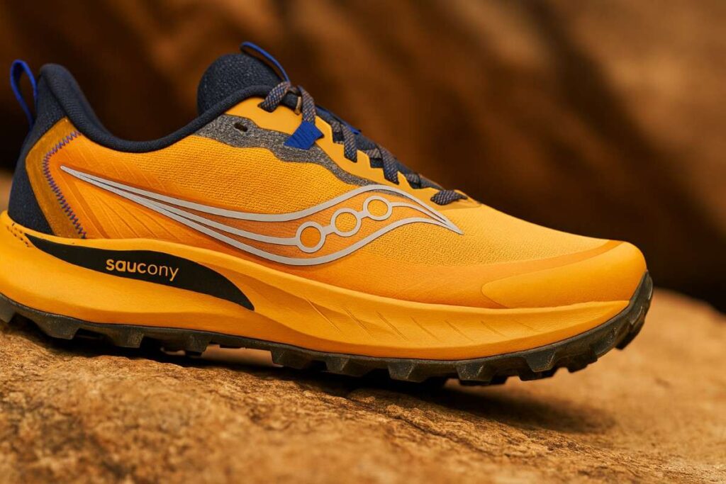 Close-up of Saucony Peregrine 15 trail running shoes on loose gravel and hardpack mix.