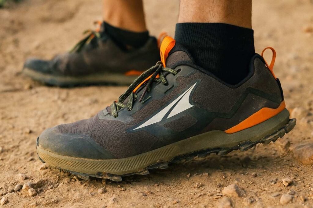 Close-up of Altra Lone Peak 7 trail running shoes gripping a dusty sandstone trail.