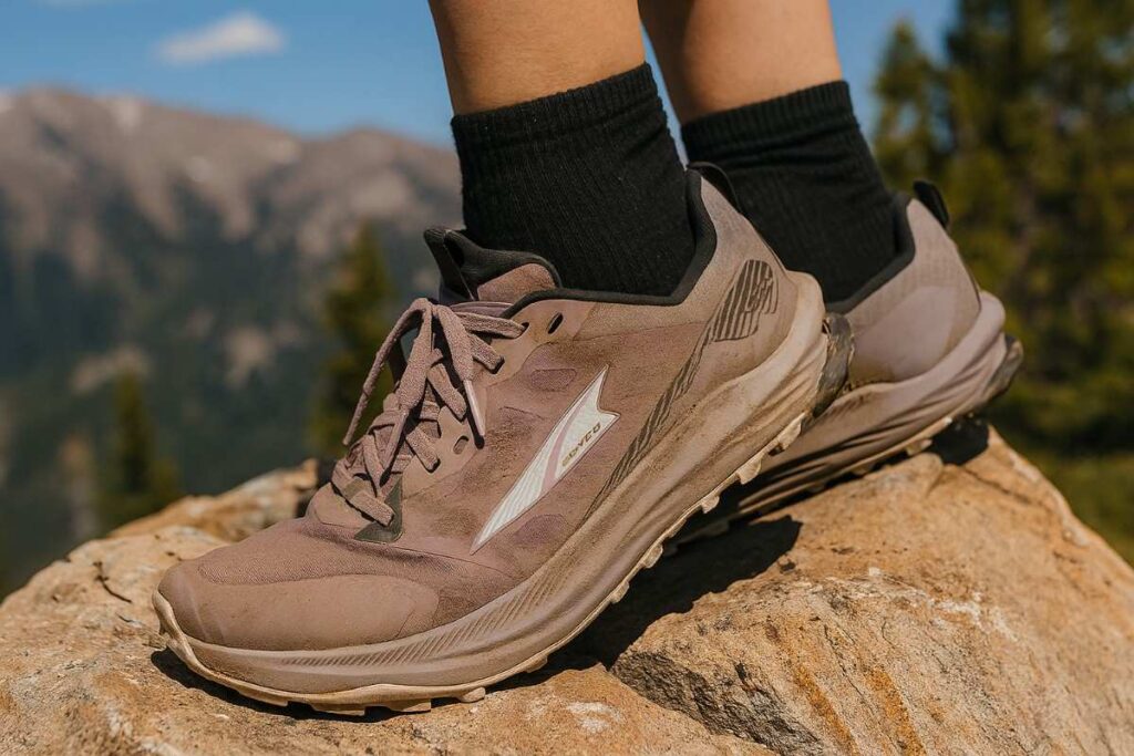 Altra Lone Peak 9 women’s trail running shoes close-up on rocky alpine scramble.