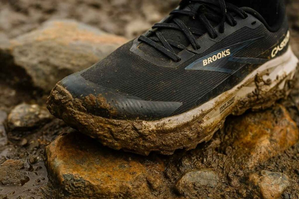 Brooks Cascadia 19 GTX waterproof trail running shoes on muddy rugged trail close-up.