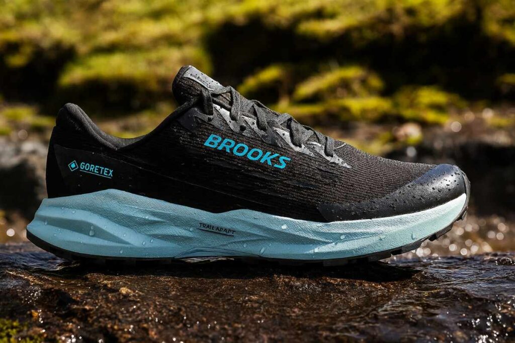 Close-up of waterproof Brooks Cascadia 19 GTX women’s shoes on wet alpine trail.