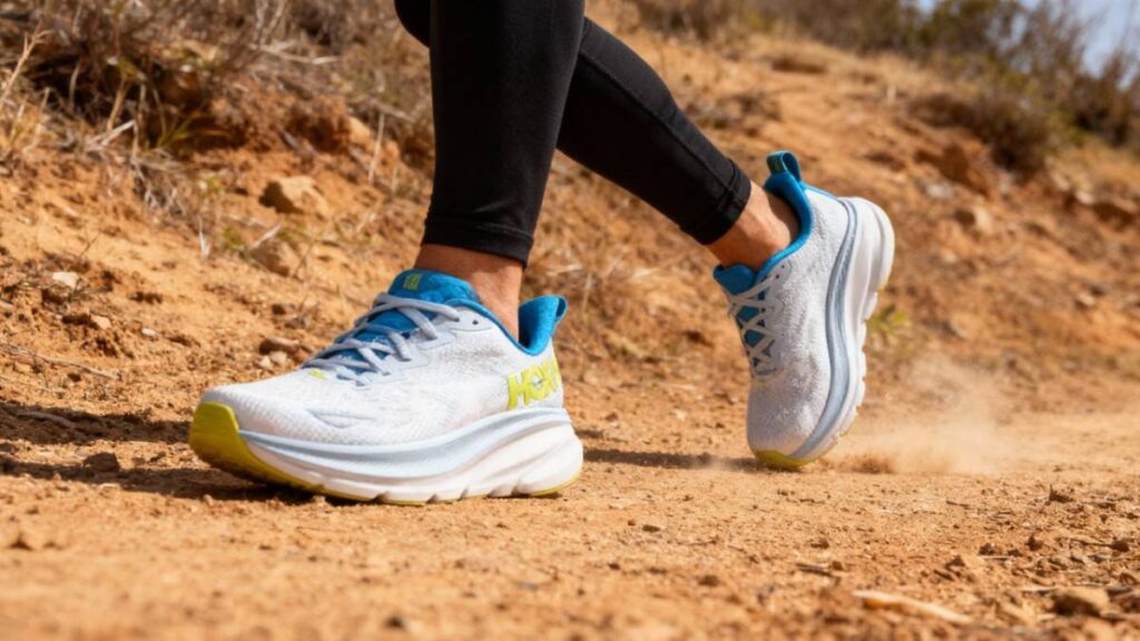 Hiker's legs walking shot wearing HOKA Clifton 9. 