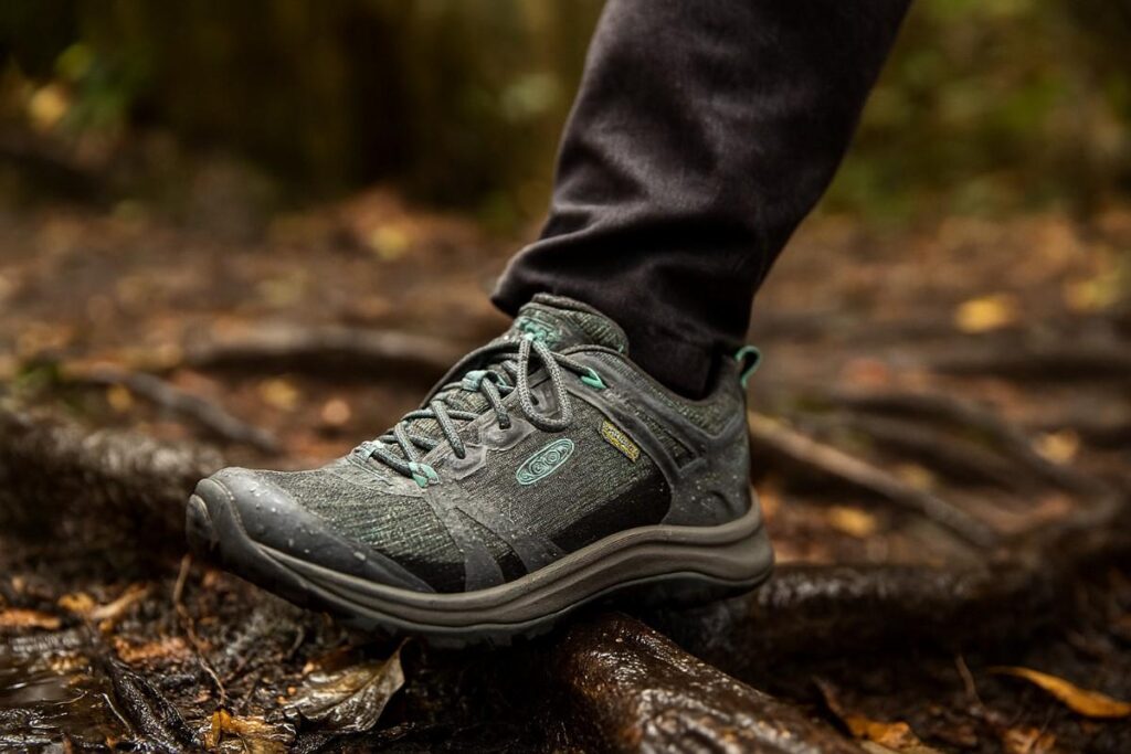 Close-up of KEEN Terradora II Waterproof women’s hiking shoes on wet forest trail.