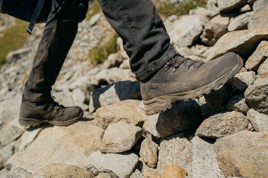 Hiker testing La Sportiva Nucleo High II GTX boots on scree slope near Pawnee Pass.