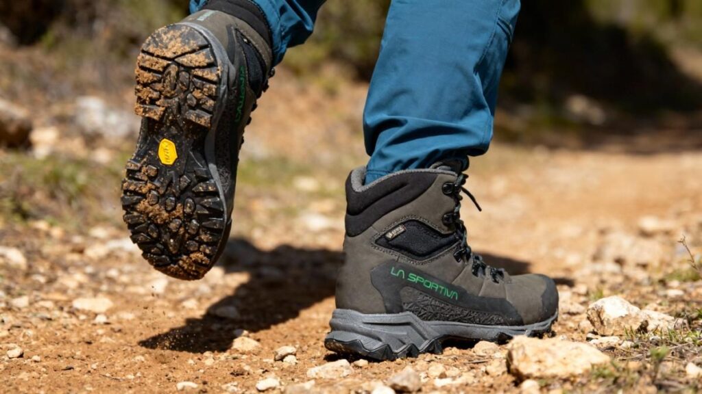 Hiker wearing best hiking boots for bunion and walking on a hiking trail. 