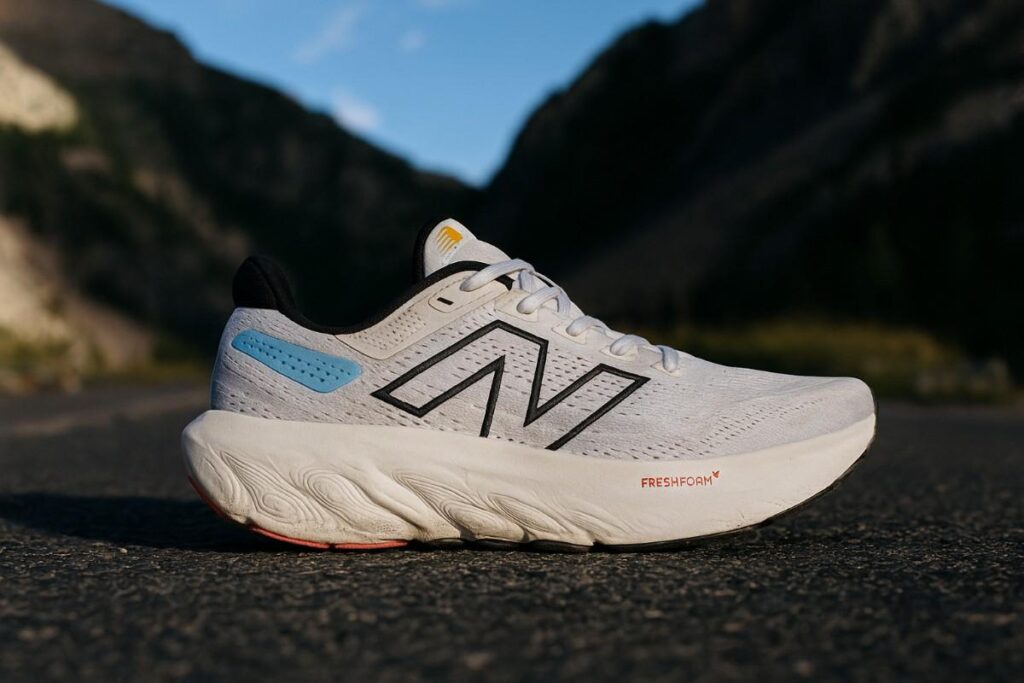 Close-up of New Balance 1080v13 on mountain approach pavement showing Fresh Foam X midsole texture.