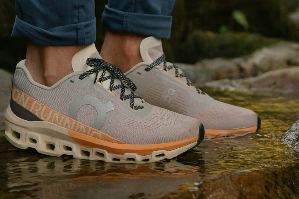 Close-up of hiker wearing On Cloudmonster 2 and standing firm in a water stream. 