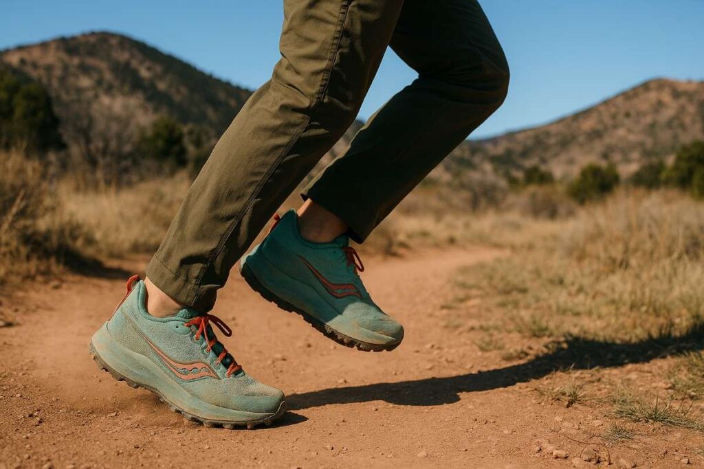 Female runner tempo-testing Saucony Peregrine 13 on dry singletrack in Colorado foothills.