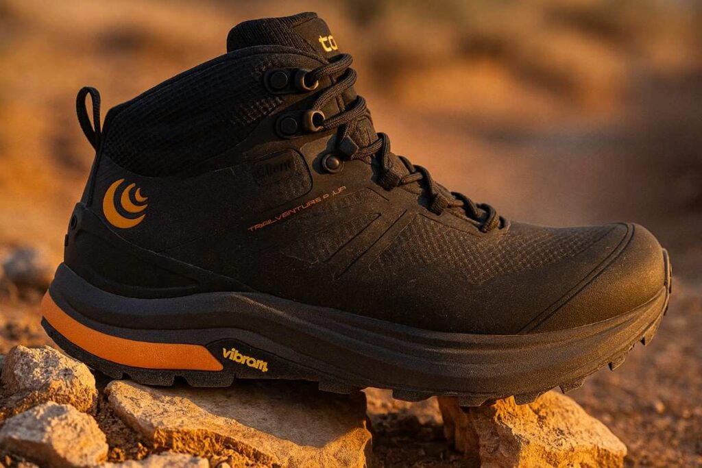 Close up of Topo Athletic Trailventrue 2 Mid WP displayed on rocks in golden hour sunlight.