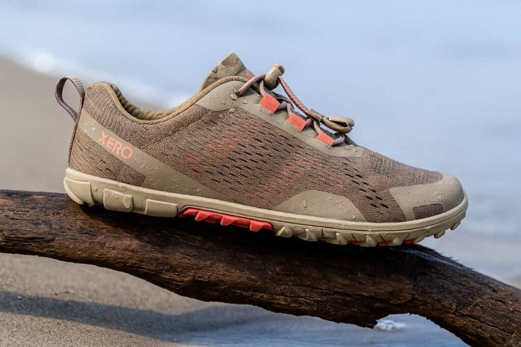 Close-up of Xero Shoes Aqua X Sport women’s water shoes on wet driftwood.