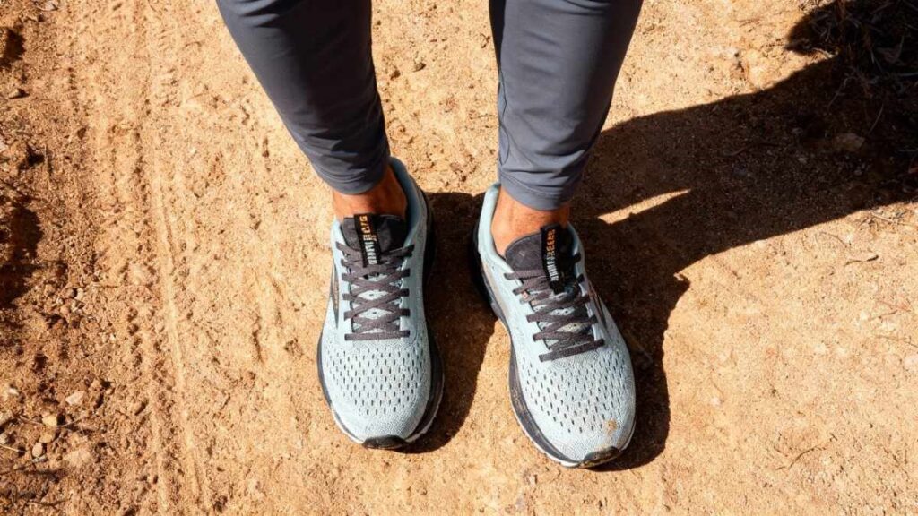 Sharp above angle-view of hiker's legs wearing Brooks Adrenaline GTS 24 on dirt trail.
