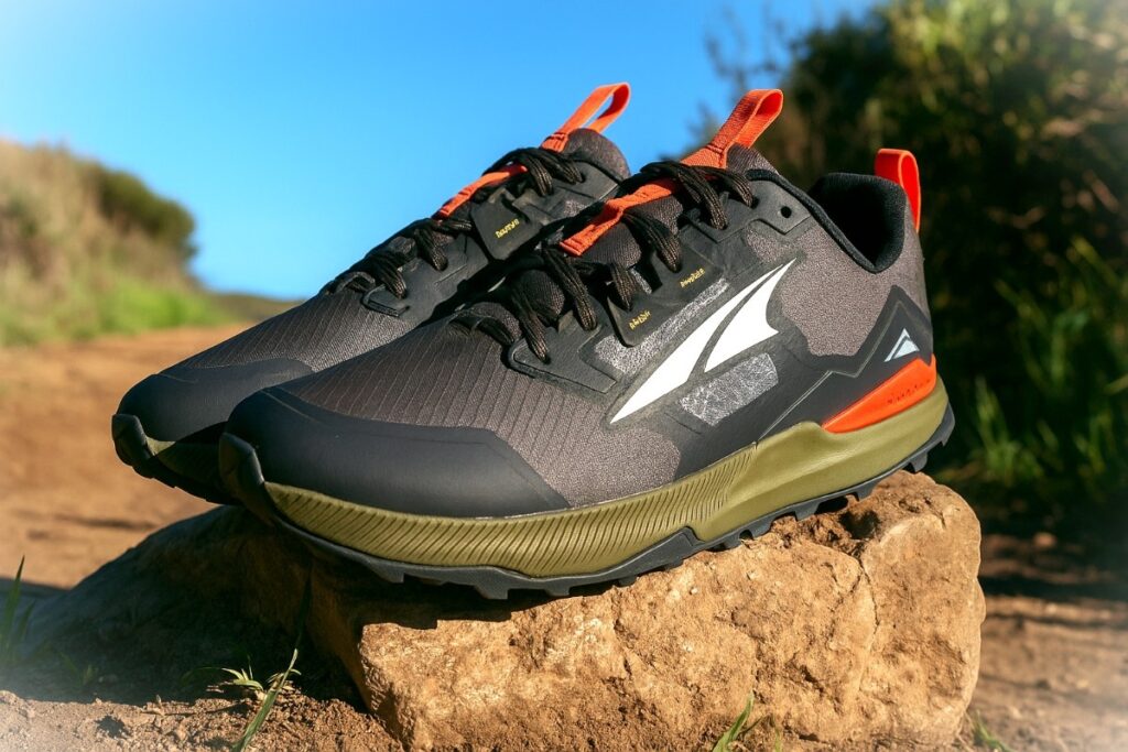 Altra Lone Peak 7 pair displayed on a rock on dirt hiking trail.