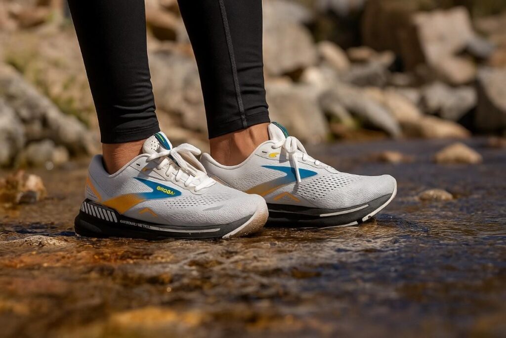 Hiker wearing Brooks Adrenaline GTS 23 standing firm in water stream.