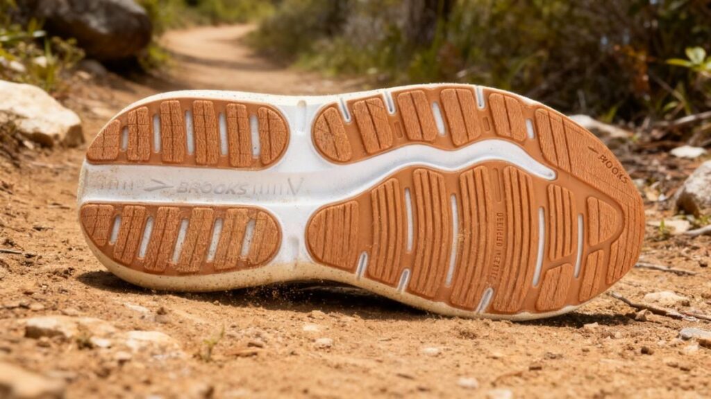 Outsole of Brooks Ghost Max 2 placed on a trail.