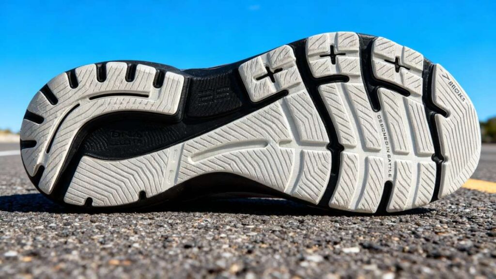 Outsole of Brooks Adrenaline GTS 23 displayed on road.