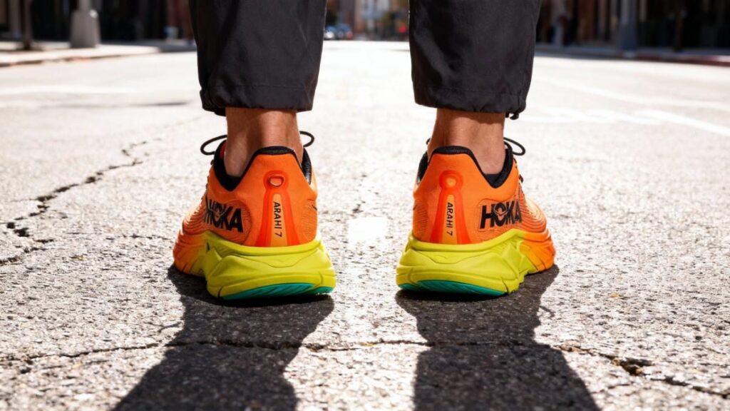 Heel view of Hoka Arahi 7 in hiker's legs.