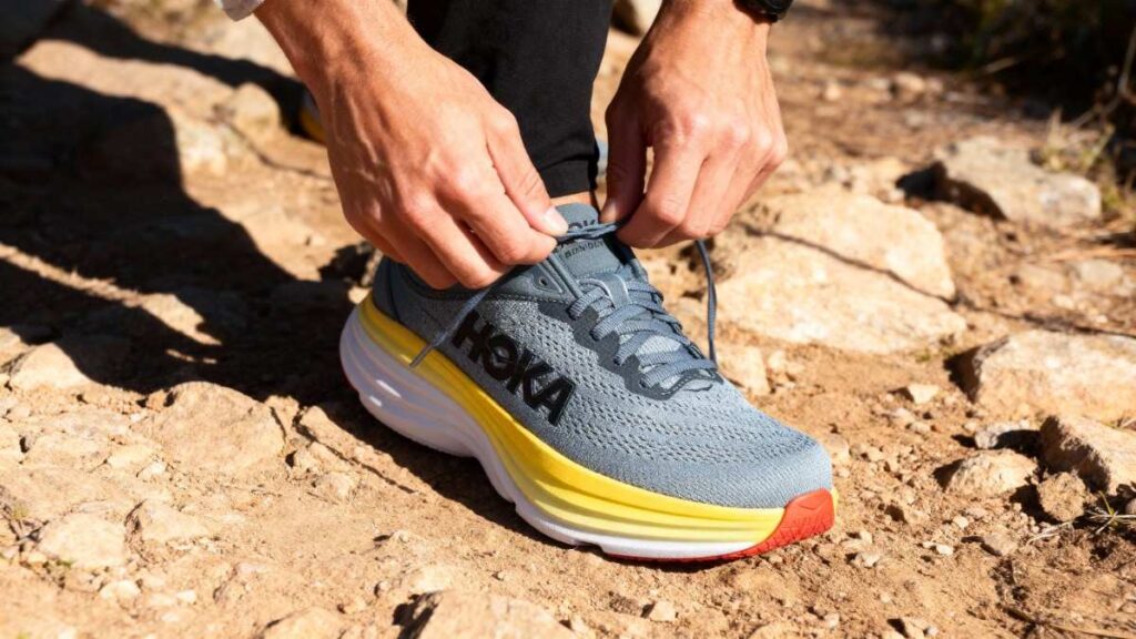 Close-up of hiker lacing up his HOKA Bondi 8.