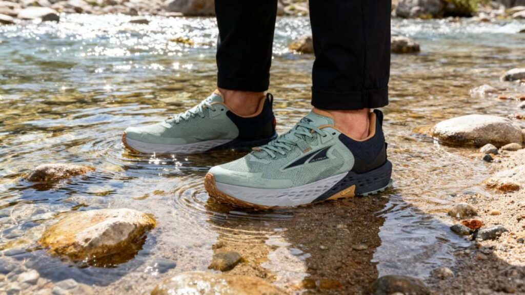 Hiker standing in a water stream wearing his Altra Timp 5.