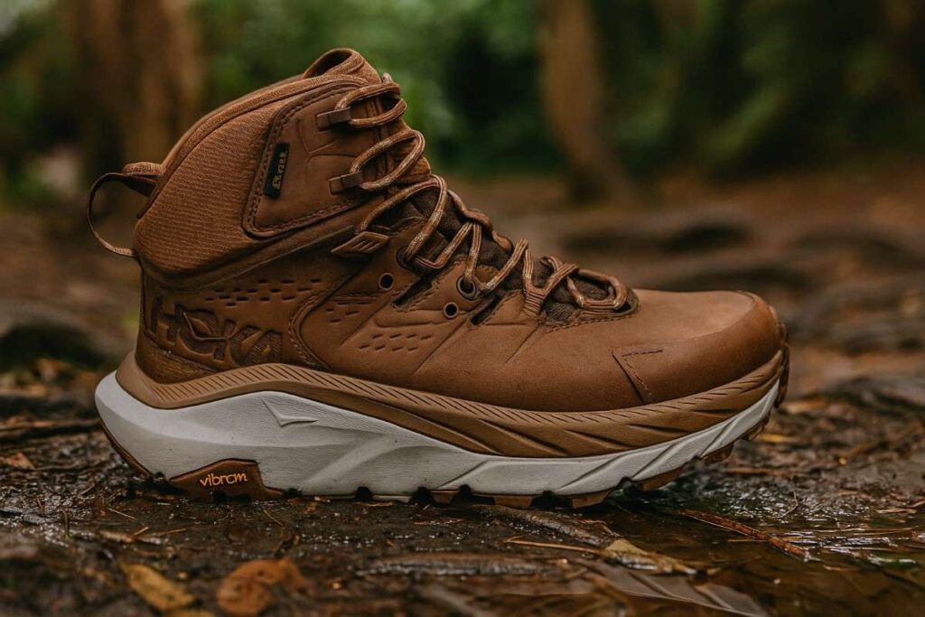 Close-up of Hoka Kaha 2 GTX on dry roots within a forest.