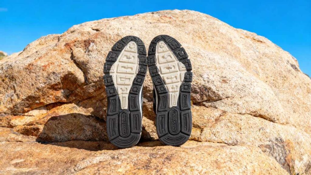 Outsole of New Balance 1540v3 placed on a rock.