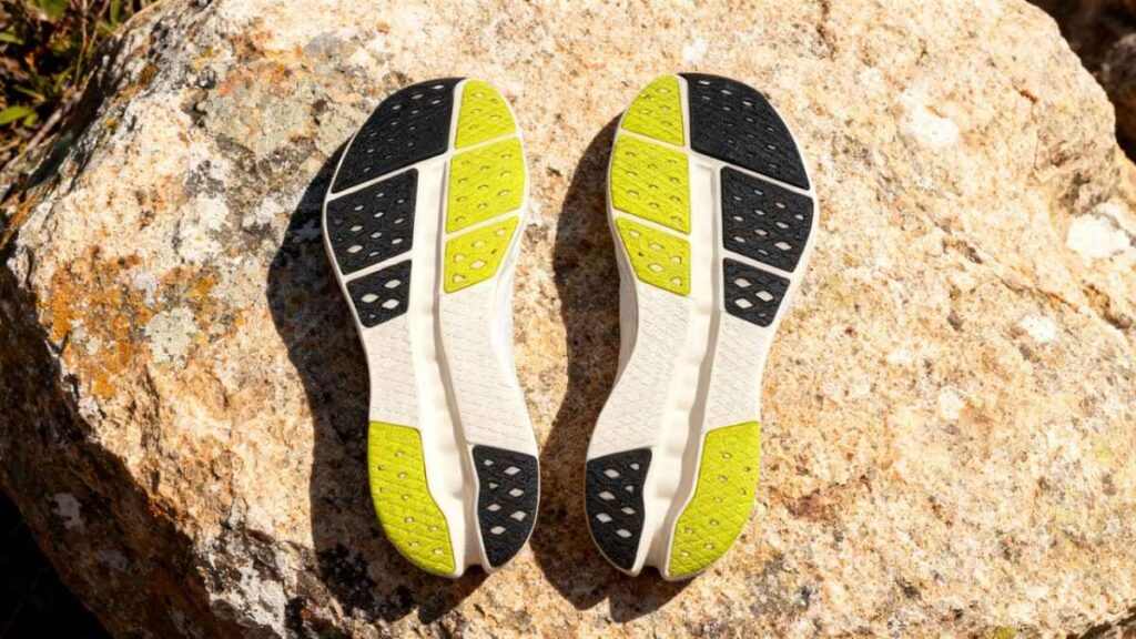 Outsoles of On Cloudsurfer 2 placed on rock surface.