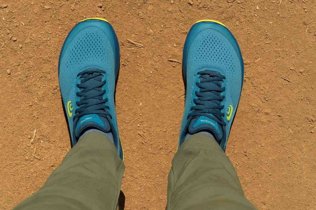 Selfie-style shot of Topo Ultraventure 3 on dirt trail.