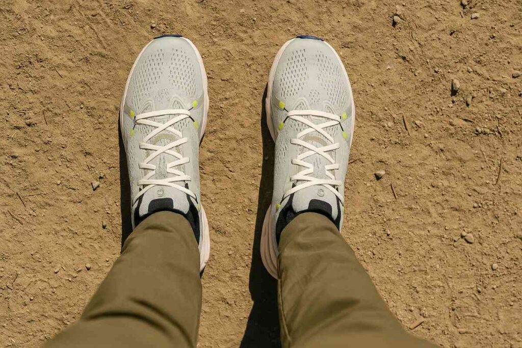 Selfie shot of hiker's legs wearing On Cloudsurfer 2 on dirt trail.