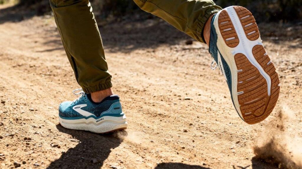 Back-angle view of hiker running with Brooks Ghost Max 2.