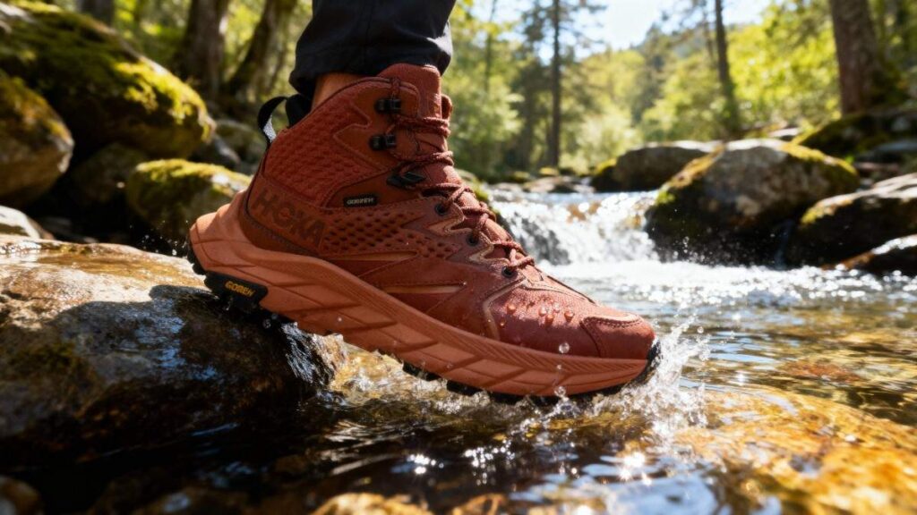 Hiker crossing the water stream wearing HOKA Anacapa Mid GTX.