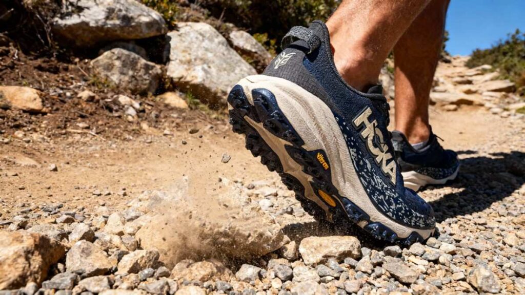 Hiker walking with HOKA Speedgoat 6 with visible outsole.