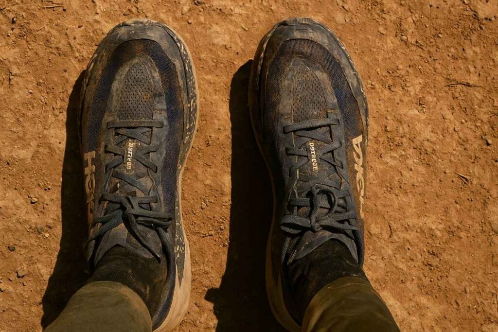 Above view shot of HOKA Speedgoat 6 uttered in dust and mud.
