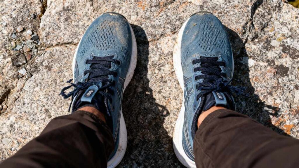 Above angle shot of hiker's legs wearing ASICS GEL-KAYANO 32.