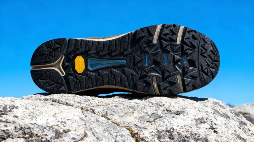 Outsole of Danner Trail 2650 GTX placed on a rocky mount surface.