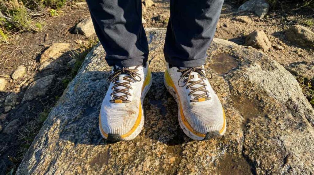 Above angle close=up of hiker wearing Hoka Bondi 7. 