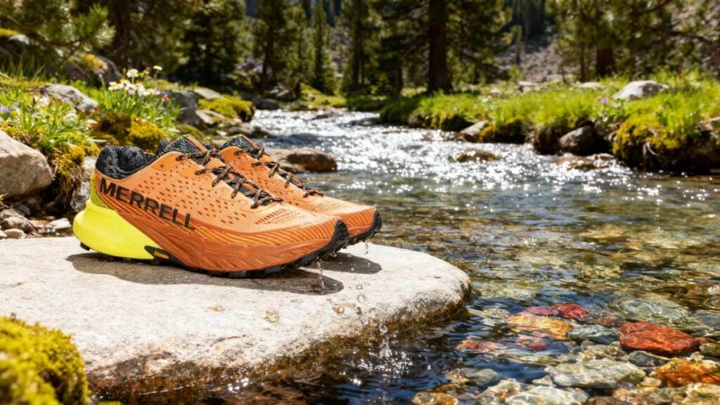 Pair of Merrell Agility Peak 5 placed on a rock within a water stream.